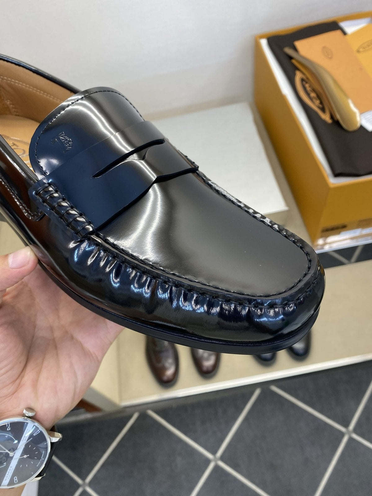 Tod's Glossy Dark Navy Penny Loafers — detail